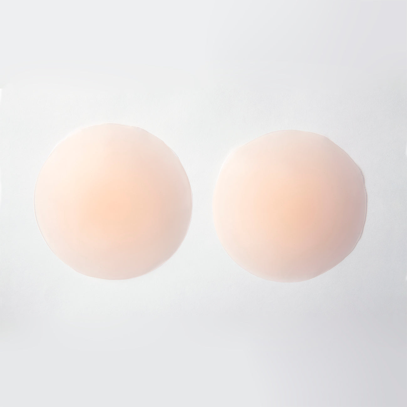 Product image of the non-adhesive concealers from the outside. They are thin and mildly opaque beige/nude.