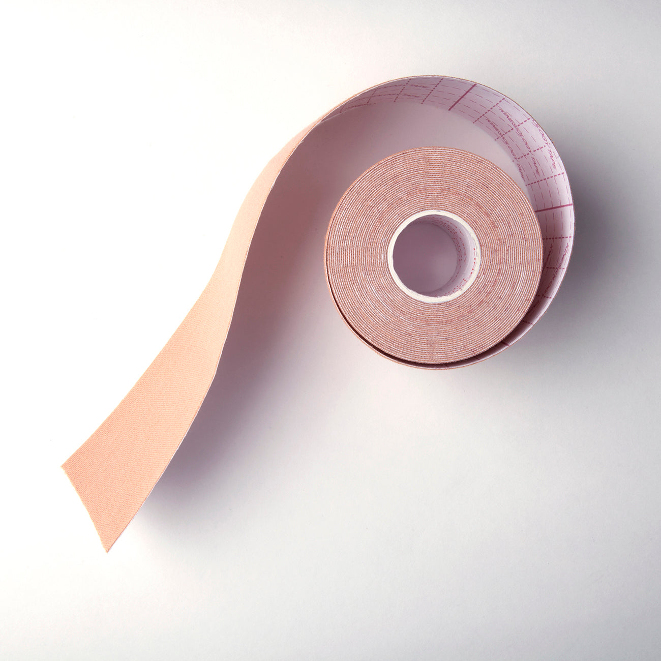 Product image of the tape roll. The tape is stretchy, opaque nude and soft.