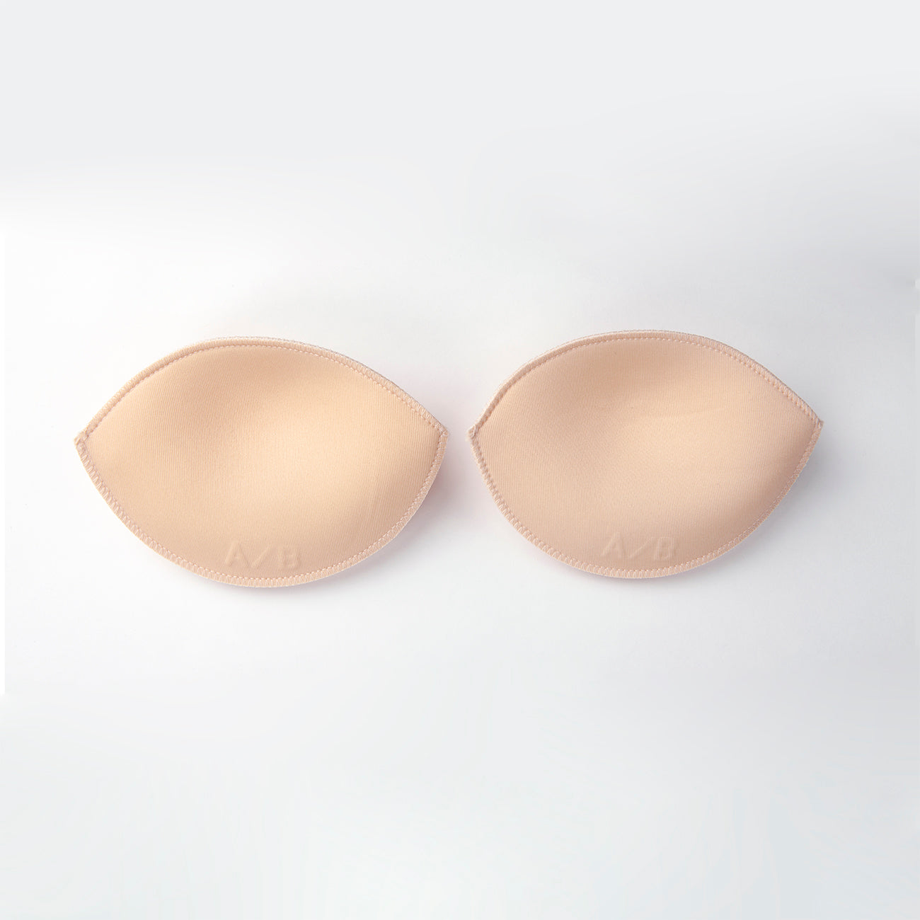 Product image of the water push up pads. They are ovals with tapered points on either side. They are nude and soft nylon on the outside.