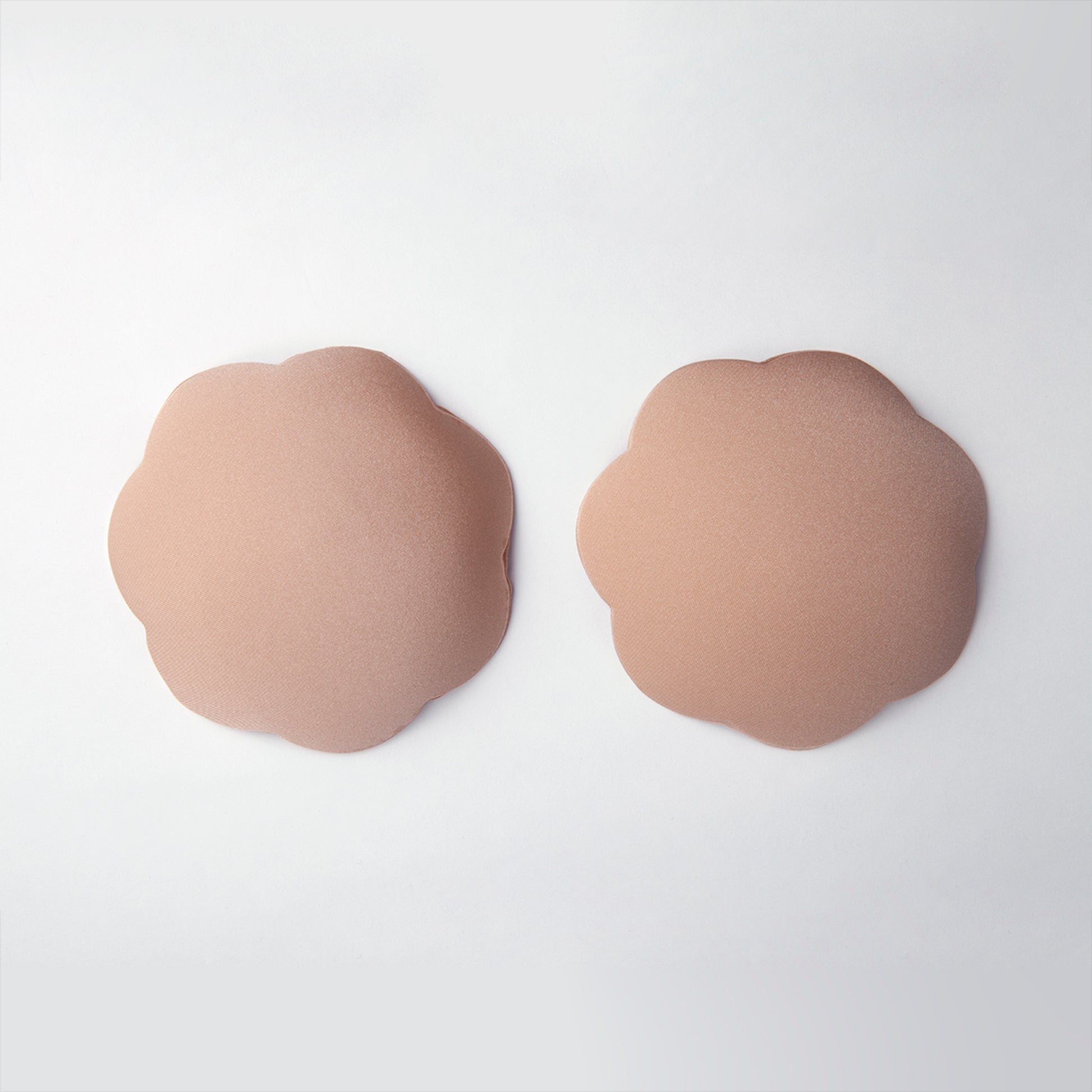 Close up product shot of water resistant petals. The outside is soft, opaque, nude in color and smooth.